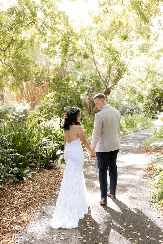 elopement couple in Brisbane walking through Mt Coot-tha Botanaical gardens with the sun streaming through the trees